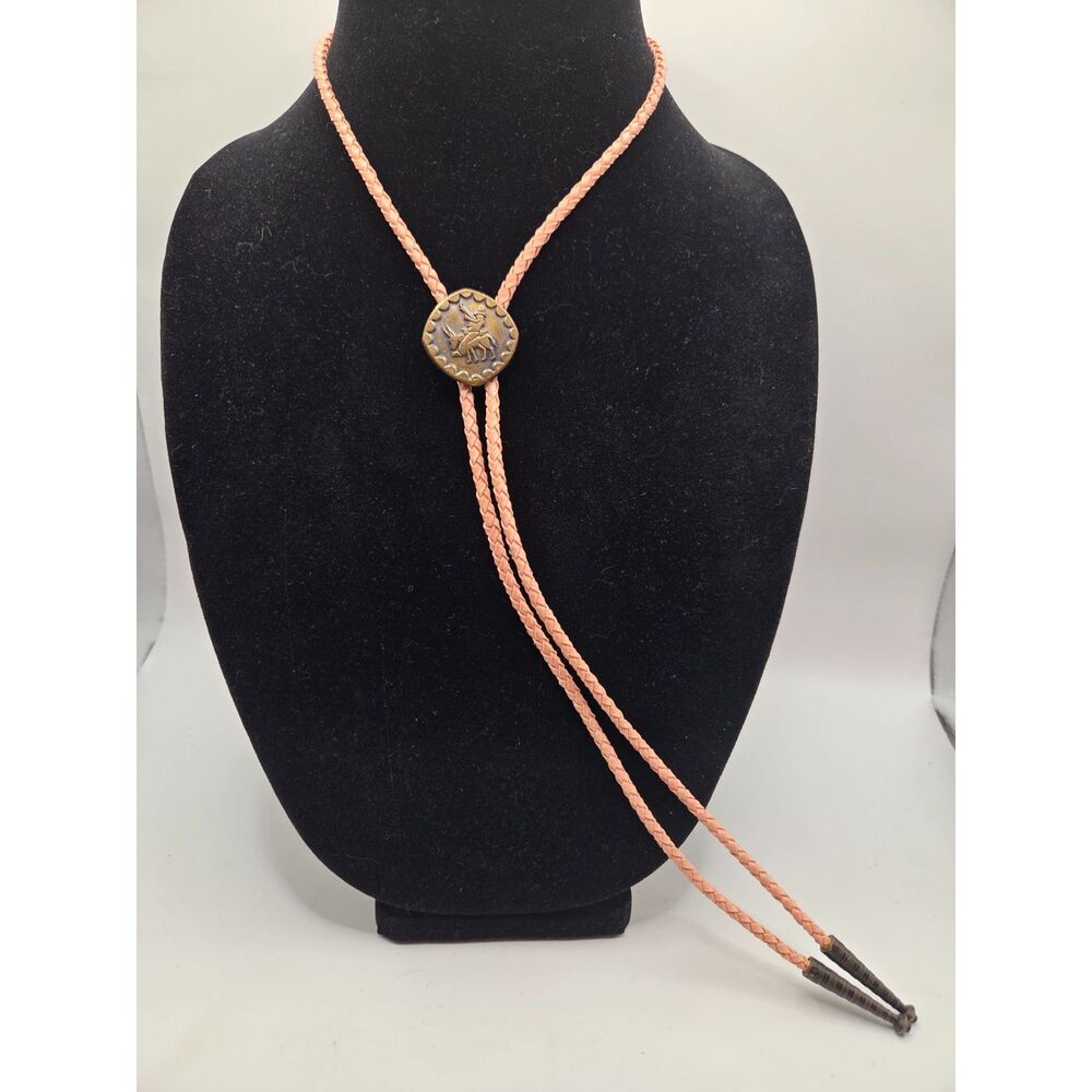 1761. Bronze Tone Bolo Tie On a Peach Braded Leather Cord